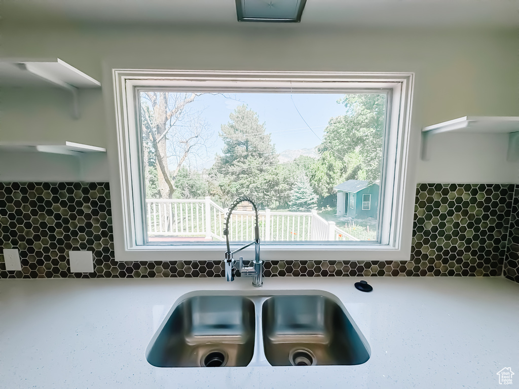 Kitchen with a sink, tasteful backsplash, and plenty of natural light