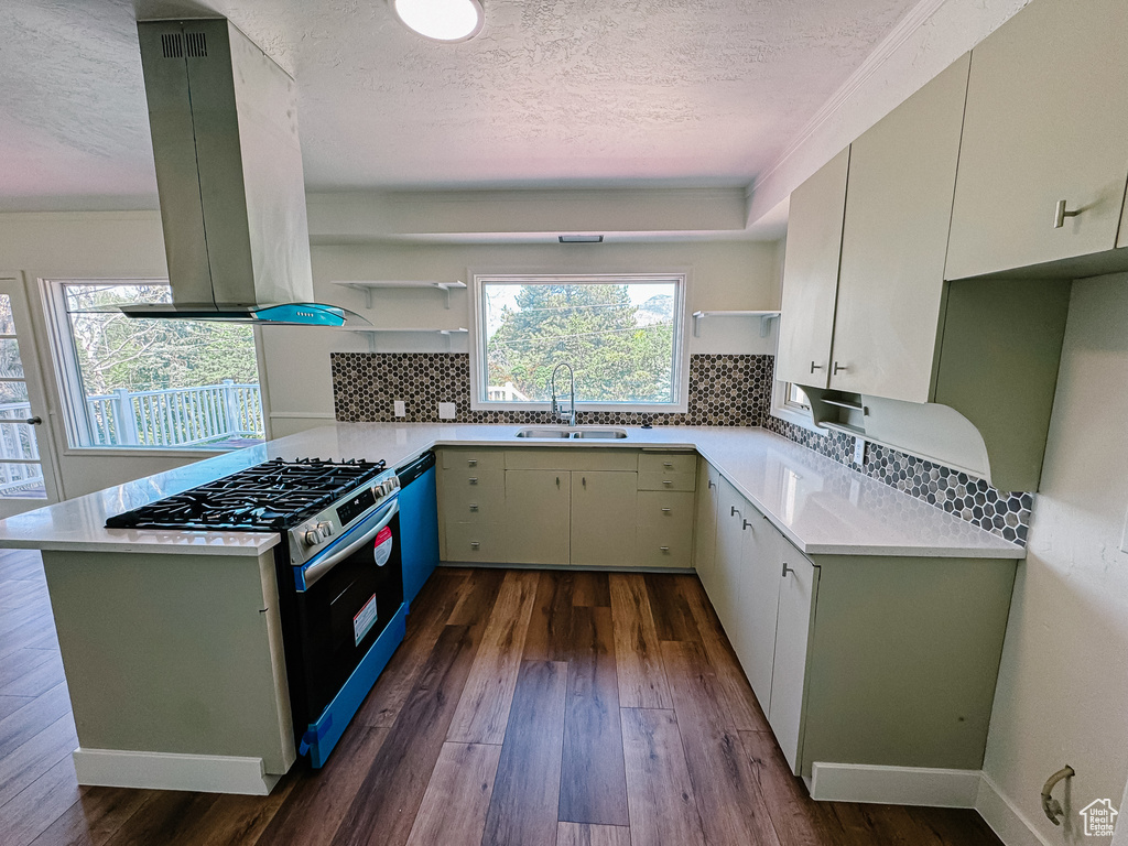 Kitchen with open shelves, a textured ceiling, island range hood, a sink, and dark wood finished floors