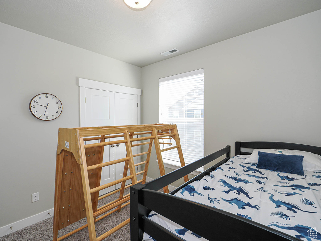 Carpeted bedroom with baseboards