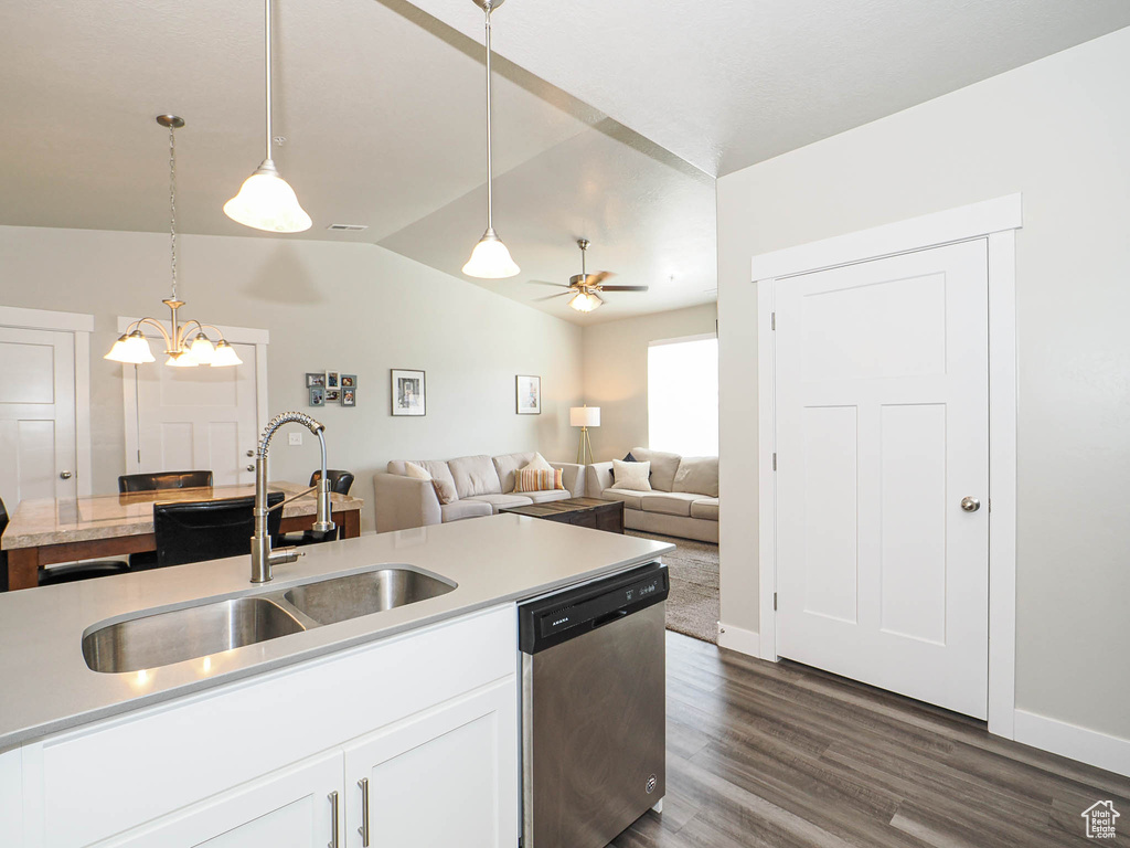 Kitchen with stainless steel dishwasher, a sink, lofted ceiling, light countertops, and ceiling fan