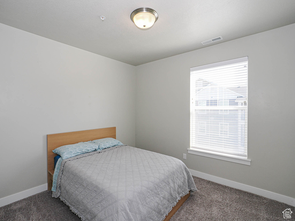 Bedroom with carpet floors and baseboards