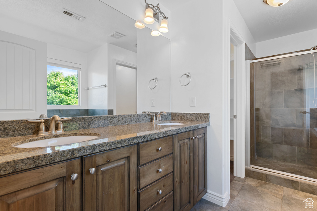 Bathroom with double vanity and a stall shower