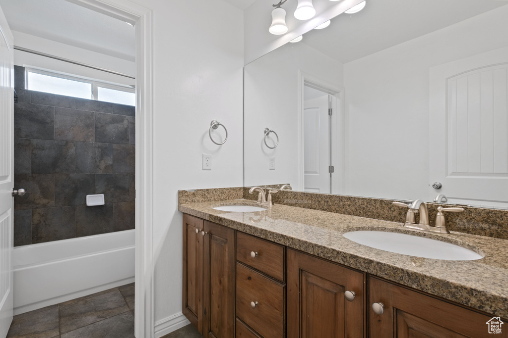 Full bath featuring double vanity and shower / bathtub combination