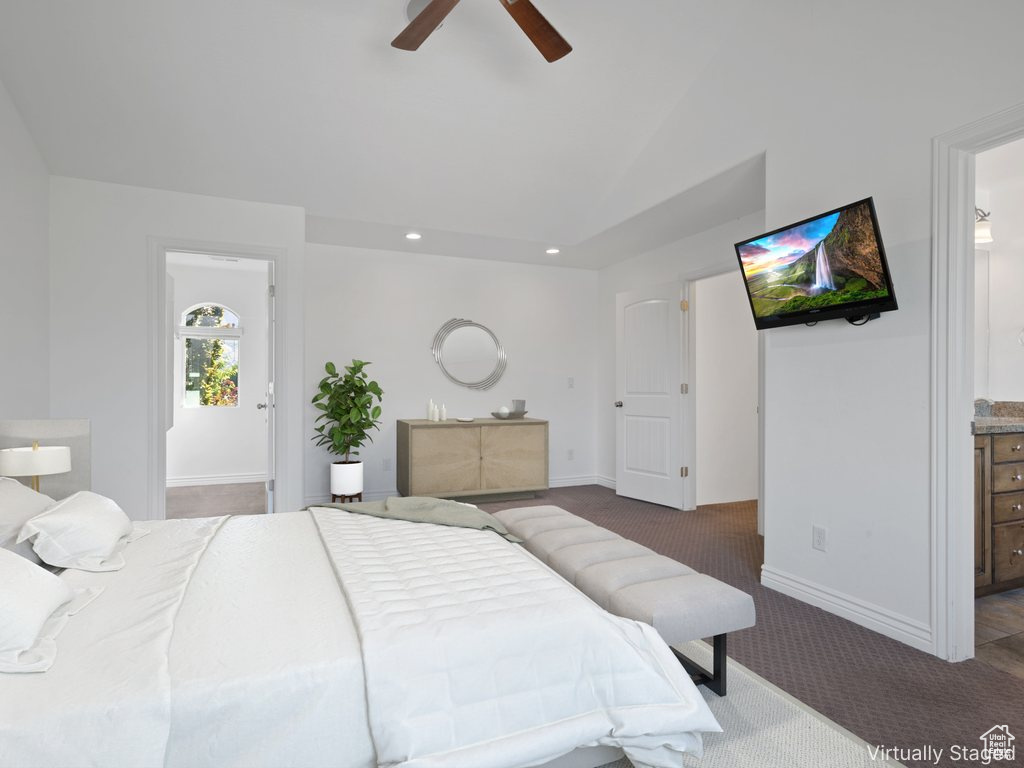 Bedroom with carpet floors, lofted ceiling, ensuite bath, baseboards, and recessed lighting