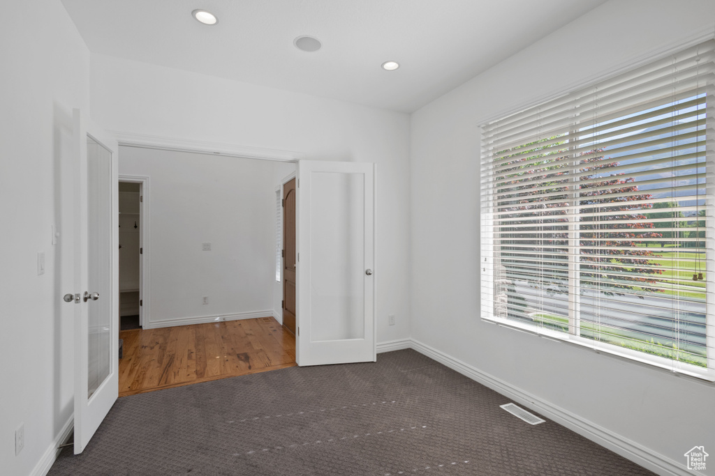 Unfurnished bedroom featuring carpet flooring, baseboards, and recessed lighting