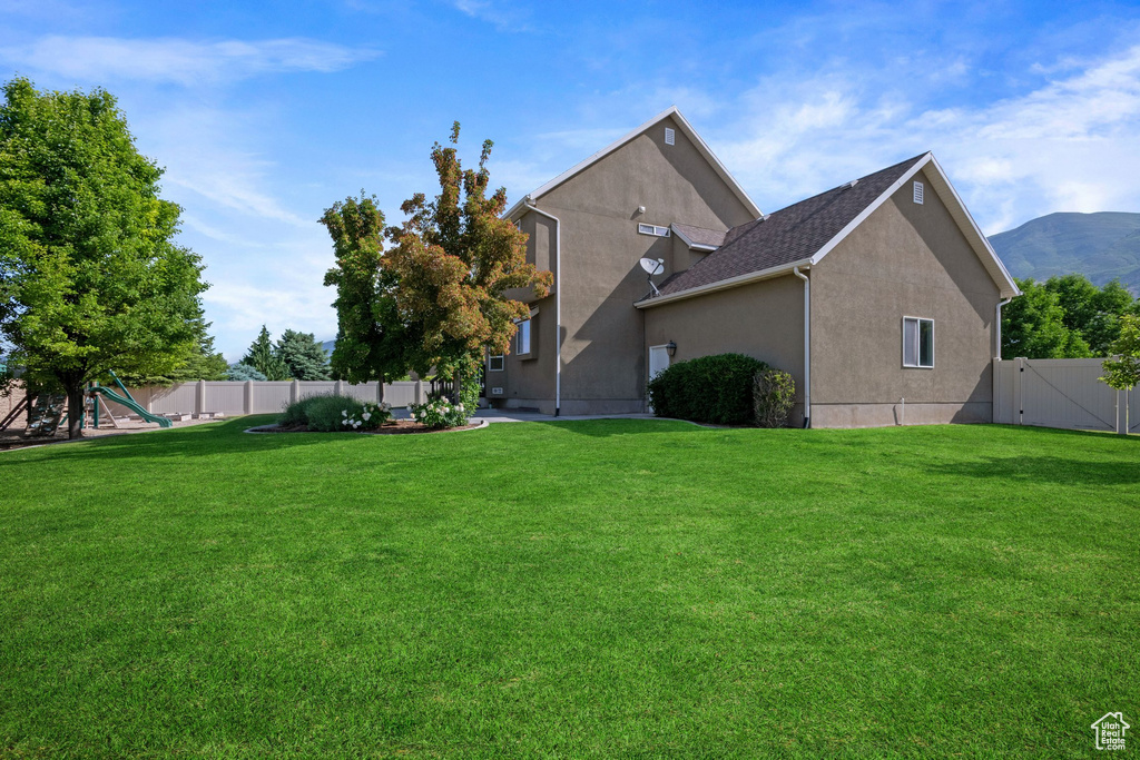 Back of house with stucco siding and a mountain view