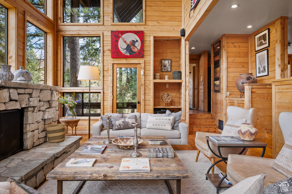 Living area featuring hardwood / wood-style flooring, wood walls, and recessed lighting