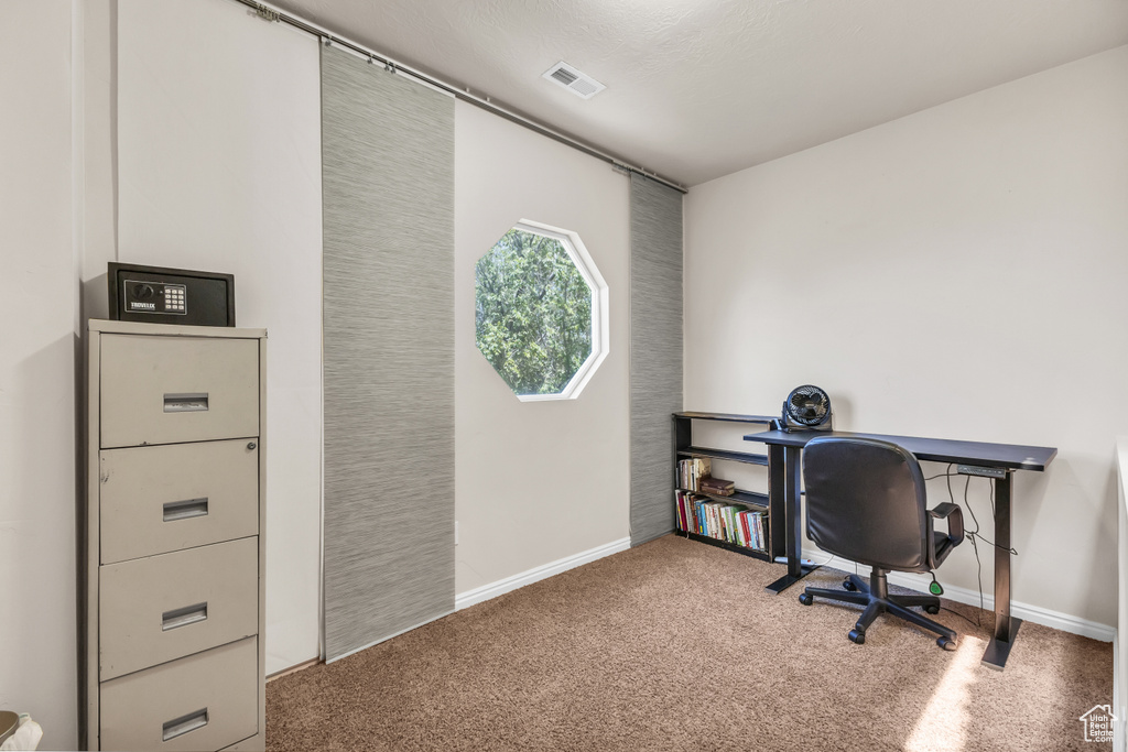 Office space featuring carpet and baseboards