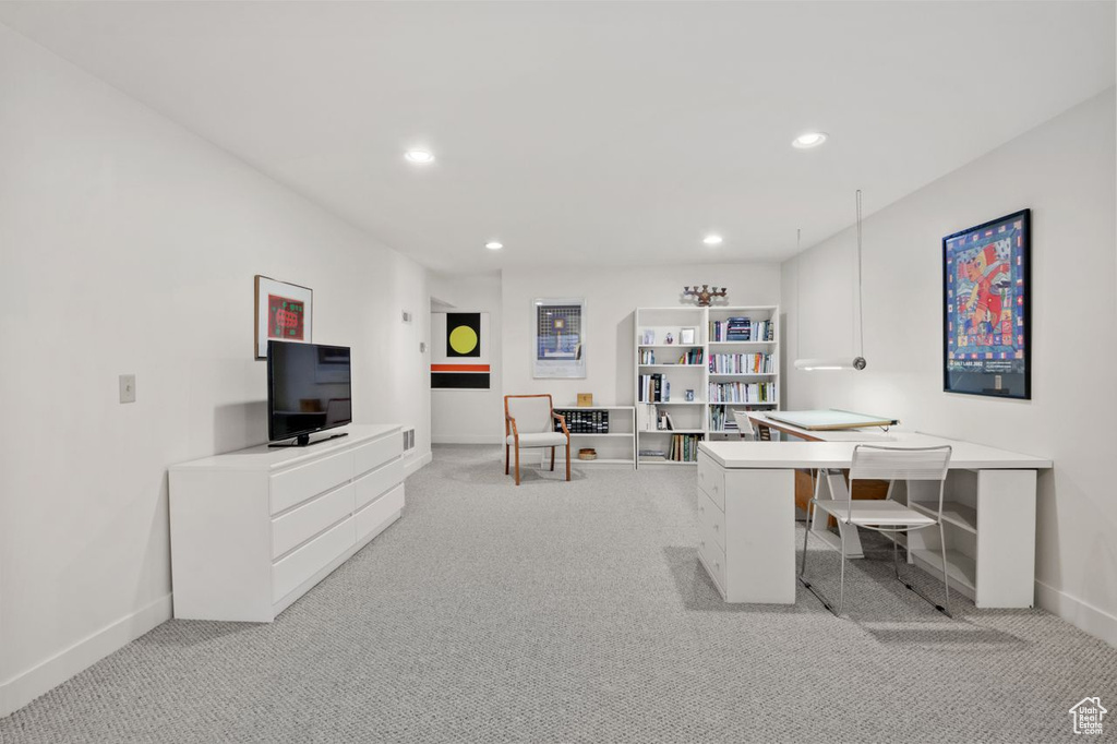 Office space featuring light colored carpet, baseboards, and recessed lighting