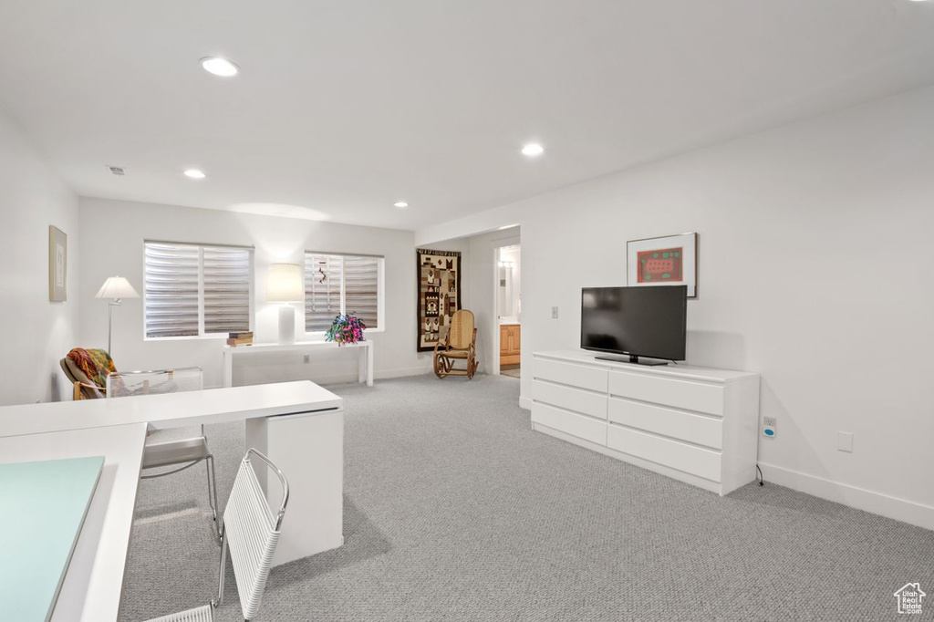Living area featuring light carpet, recessed lighting, and baseboards