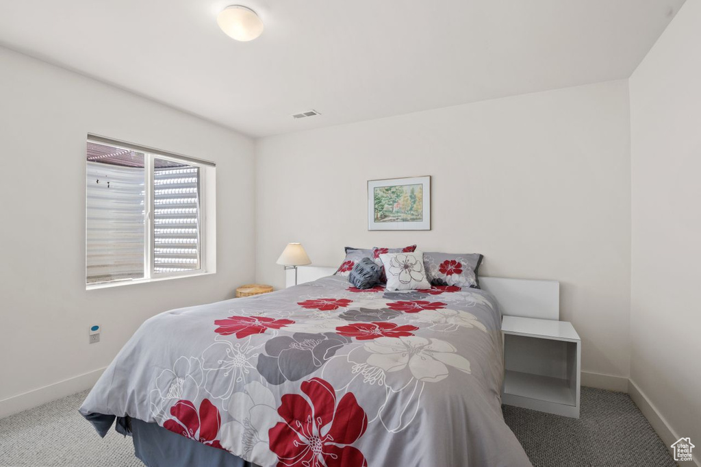 Bedroom with carpet flooring and baseboards