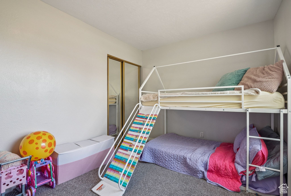 Bedroom featuring carpet floors and a closet