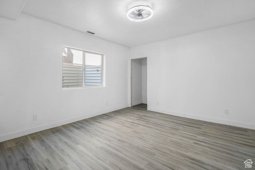 Spare room featuring wood finished floors and baseboards