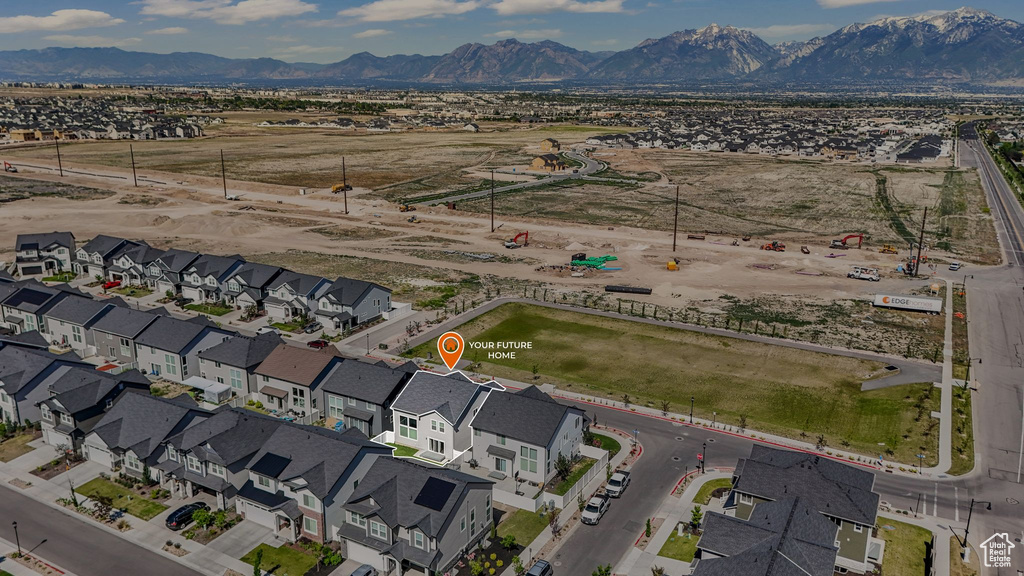 Aerial overview of property's location with a mountain backdrop and nearby suburban area