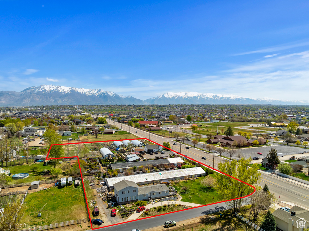 Aerial perspective of suburban area featuring property boundaries highlighted and mountains