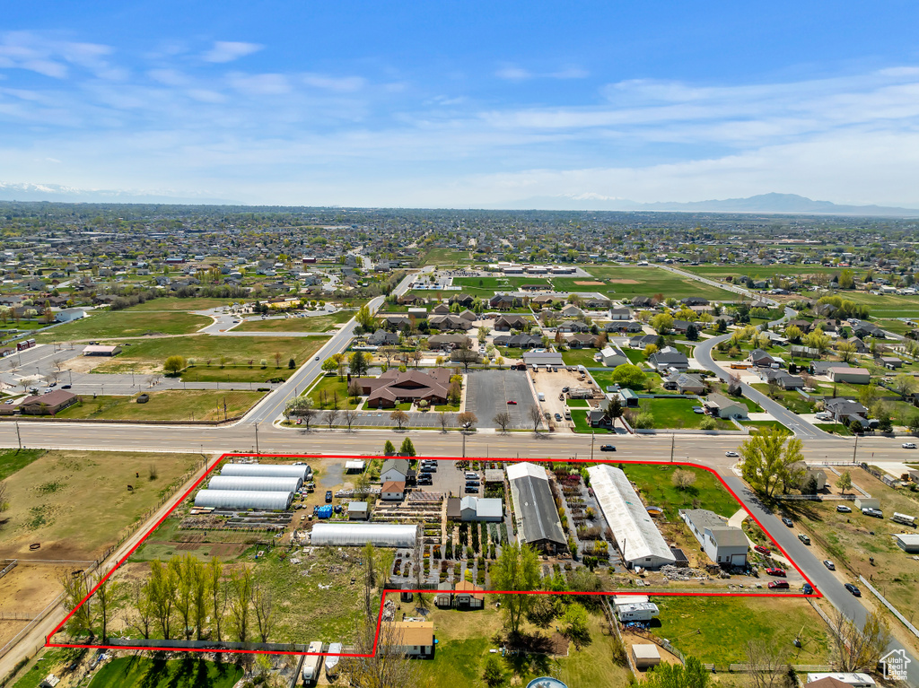 Aerial overview of property's location featuring property boundaries highlighted and a mountainous background