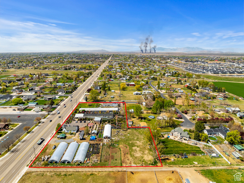 Aerial overview of property's location with property parcel outlined and a mountain backdrop