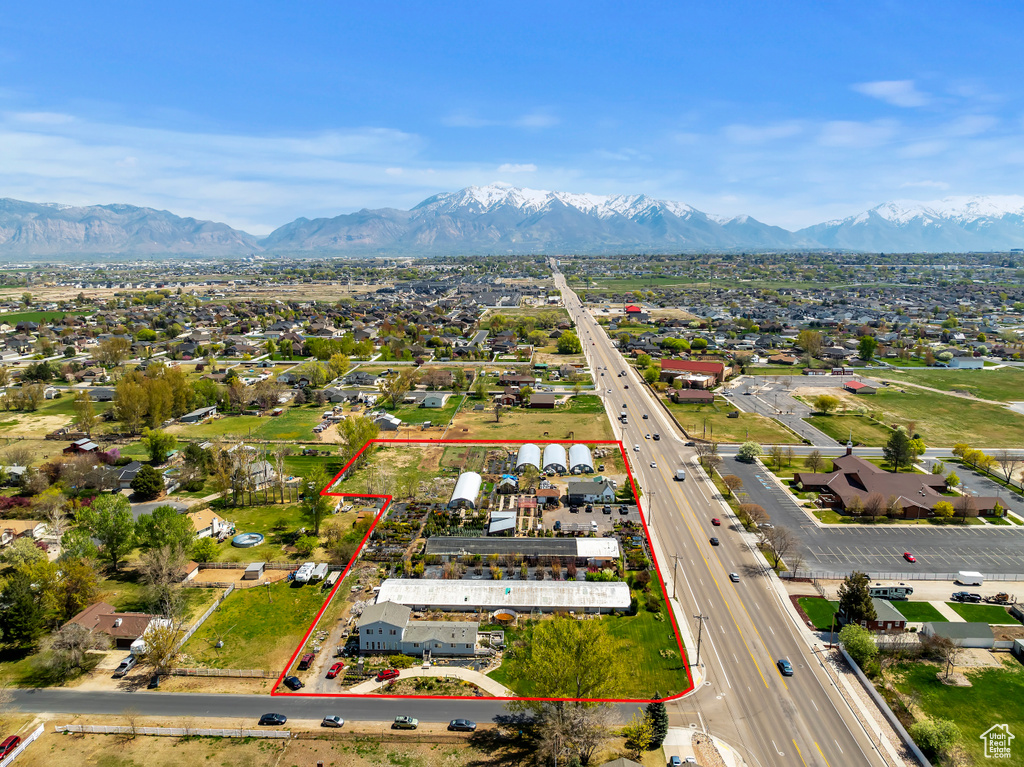 Aerial view of property's location featuring a major roadway, property parcel outlined, and mountains