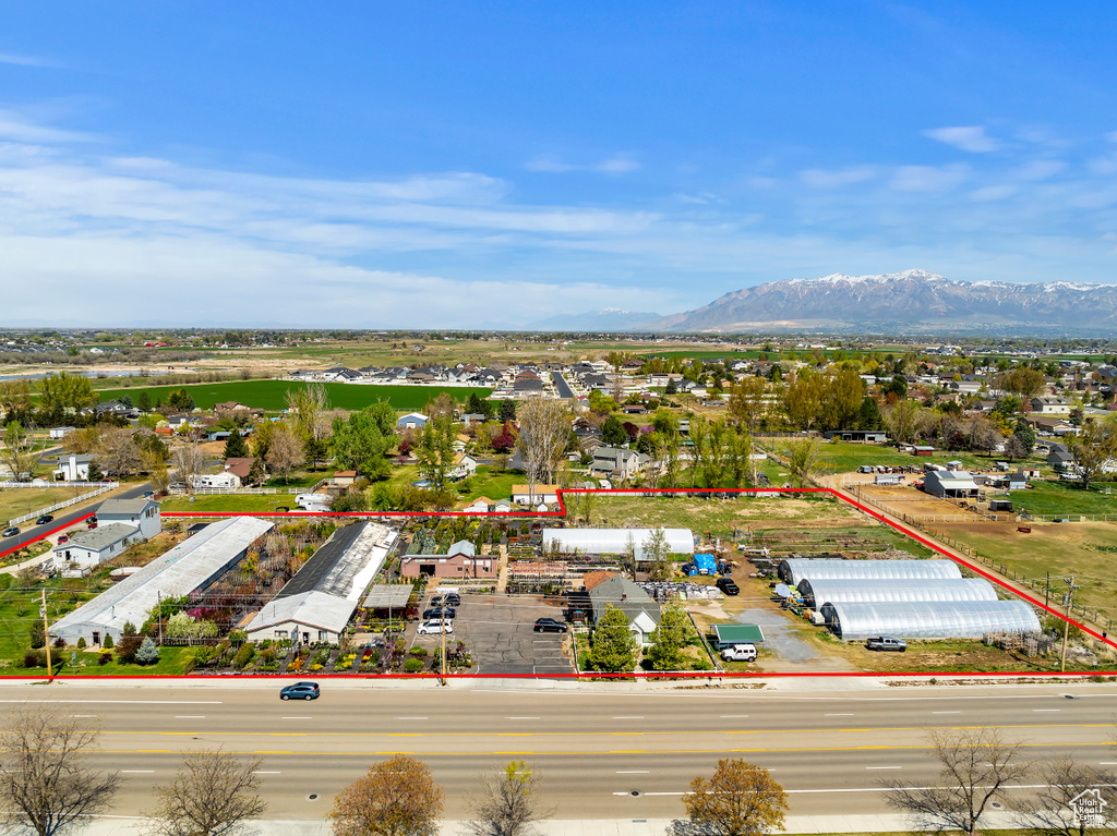 Aerial overview of property's location featuring property boundaries highlighted and a mountainous background