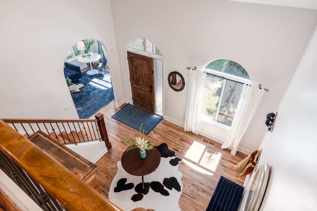 Entrance foyer with a high ceiling, wood finished floors, and baseboards