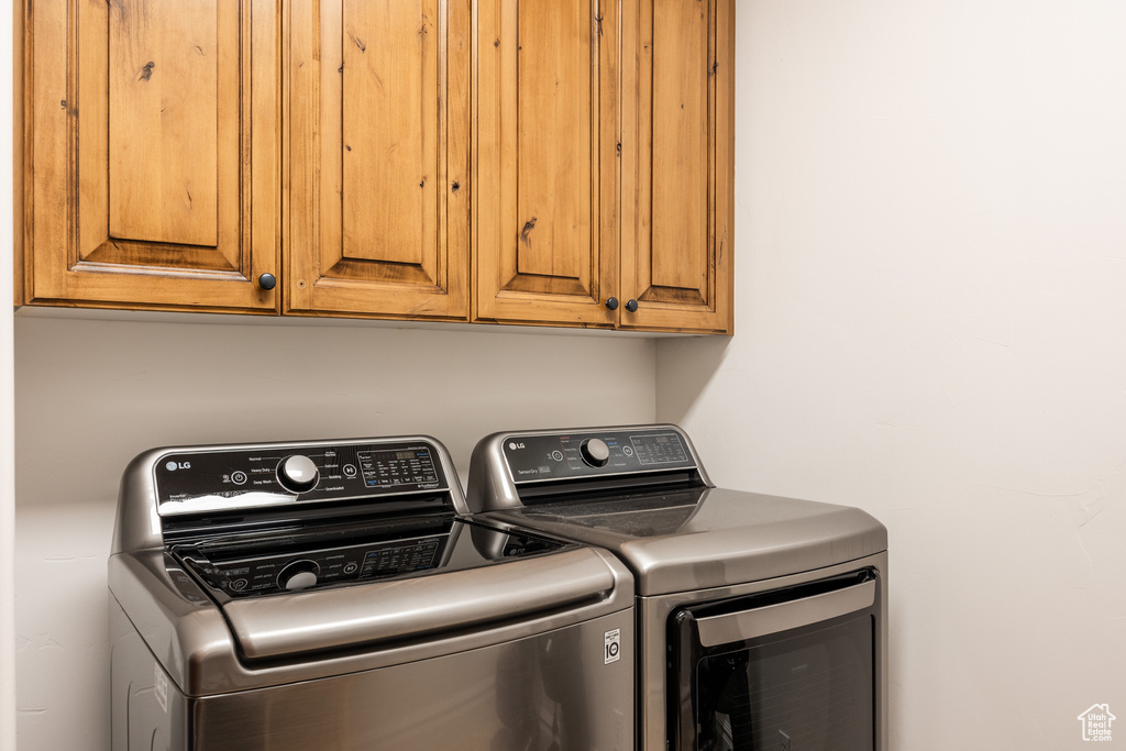 Laundry room featuring washer and dryer and cabinet space