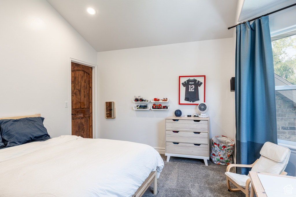 Bedroom featuring lofted ceiling, dark carpet, and recessed lighting