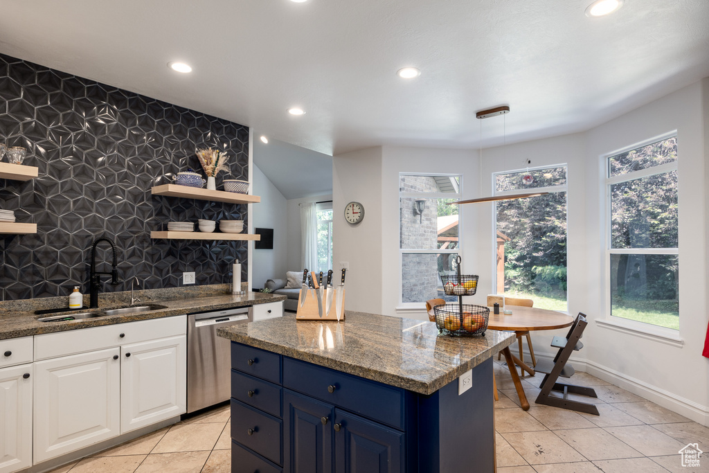 Kitchen with dishwasher, a sink, open shelves, recessed lighting, and light tile patterned floors