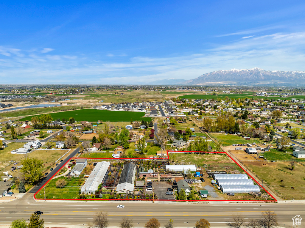 Aerial view of property's location featuring property parcel outlined and a water and mountain view