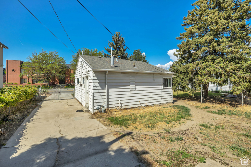 View of outbuilding featuring a gate