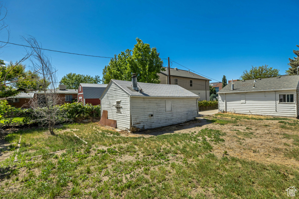 Back of property featuring a lawn