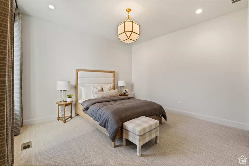 Carpeted bedroom with baseboards and recessed lighting