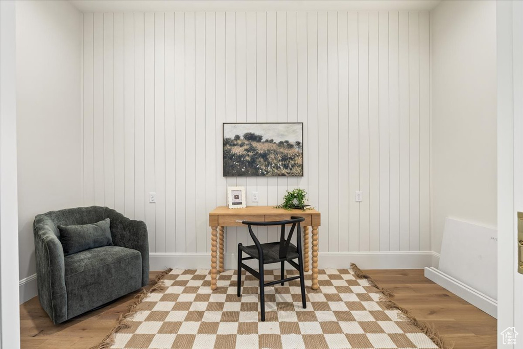 Office area featuring light wood-style flooring and baseboards