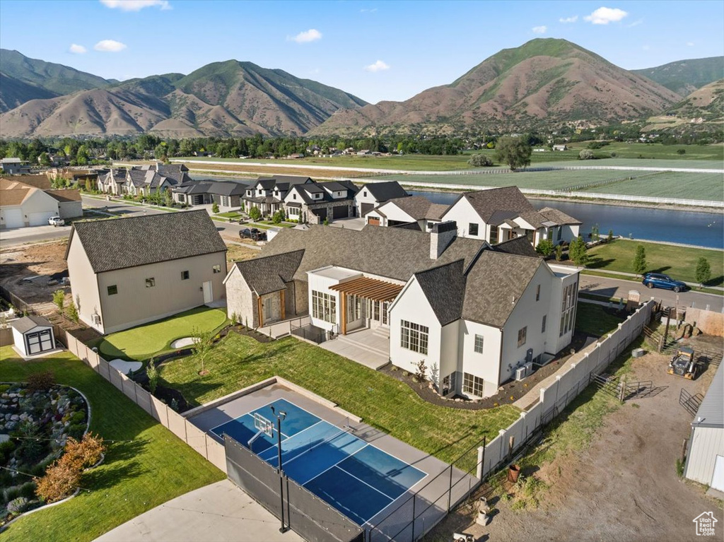 View of mountain background featuring a large body of water and nearby suburban area