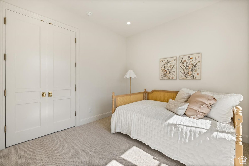 Carpeted bedroom featuring a closet, baseboards, and recessed lighting