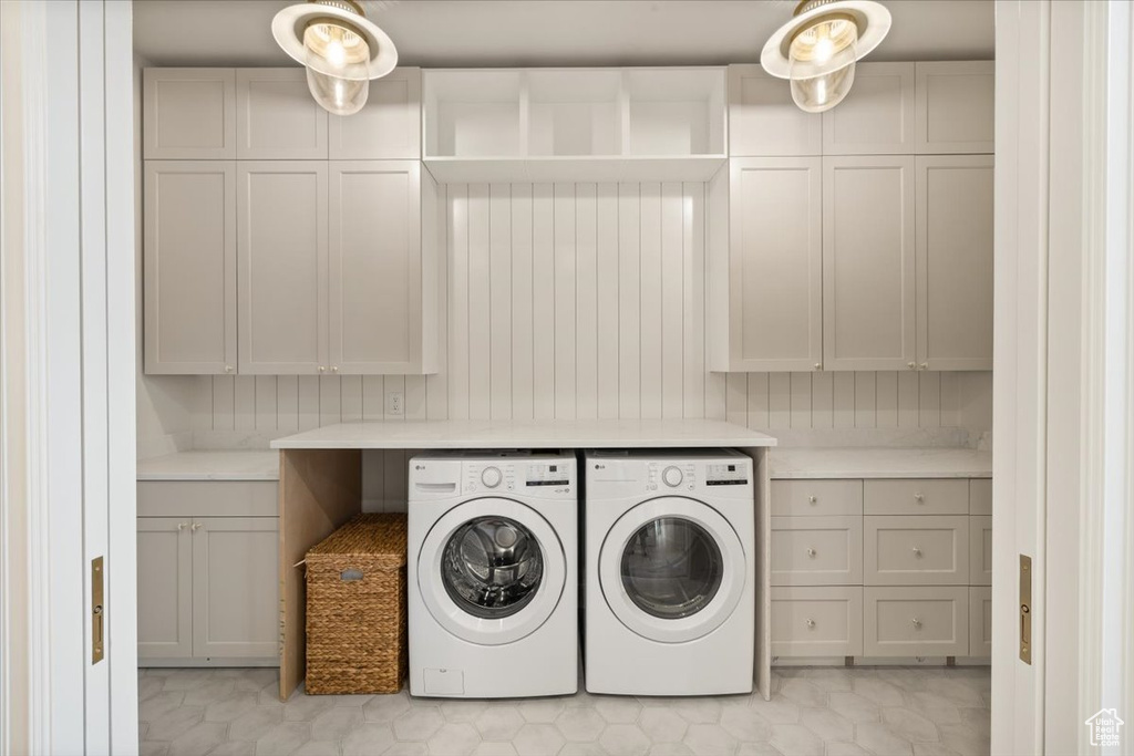 Laundry area with washer and clothes dryer and cabinet space