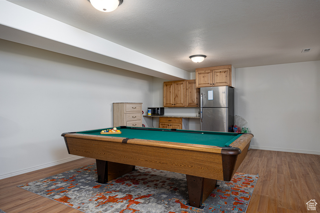 Recreation room with wood finished floors, billiards table, and baseboards