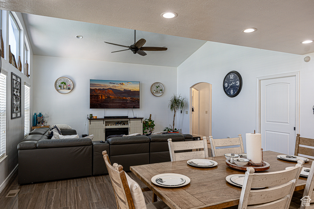 Dining space featuring ceiling fan, arched walkways, lofted ceiling, recessed lighting, and baseboards