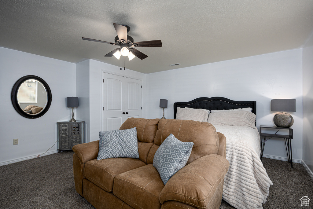 Bedroom with carpet flooring, baseboards, a closet, and a ceiling fan