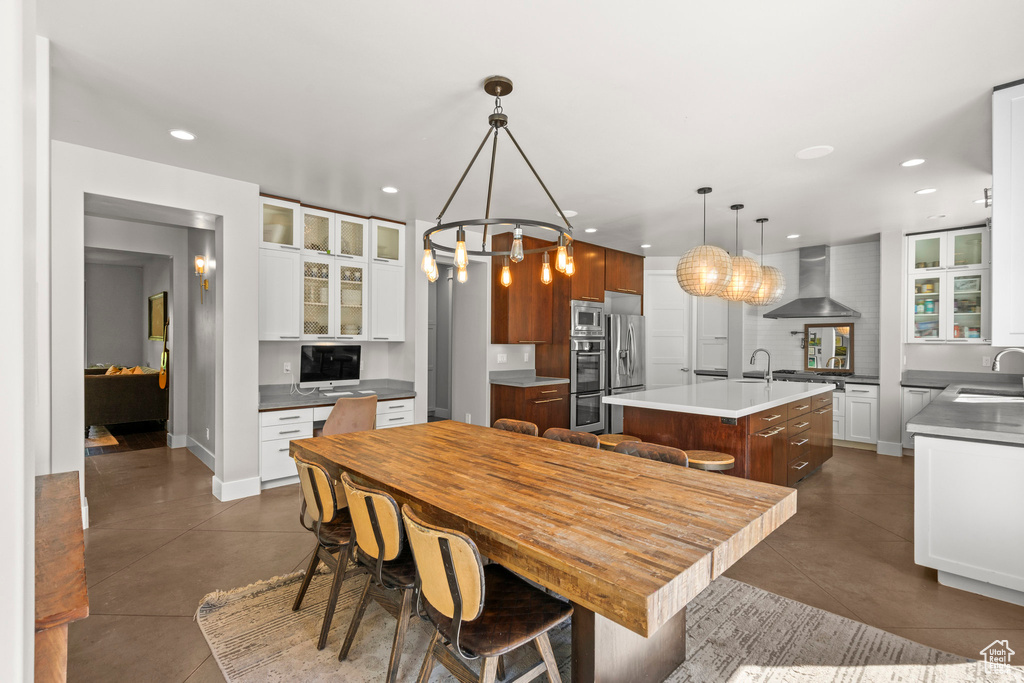 Dining area with recessed lighting, a chandelier, dark tile patterned flooring, and baseboards