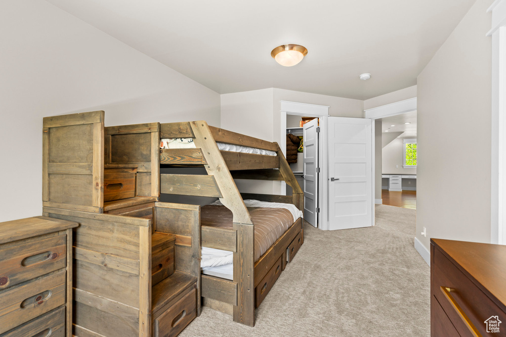 Bedroom featuring carpet floors and a spacious closet