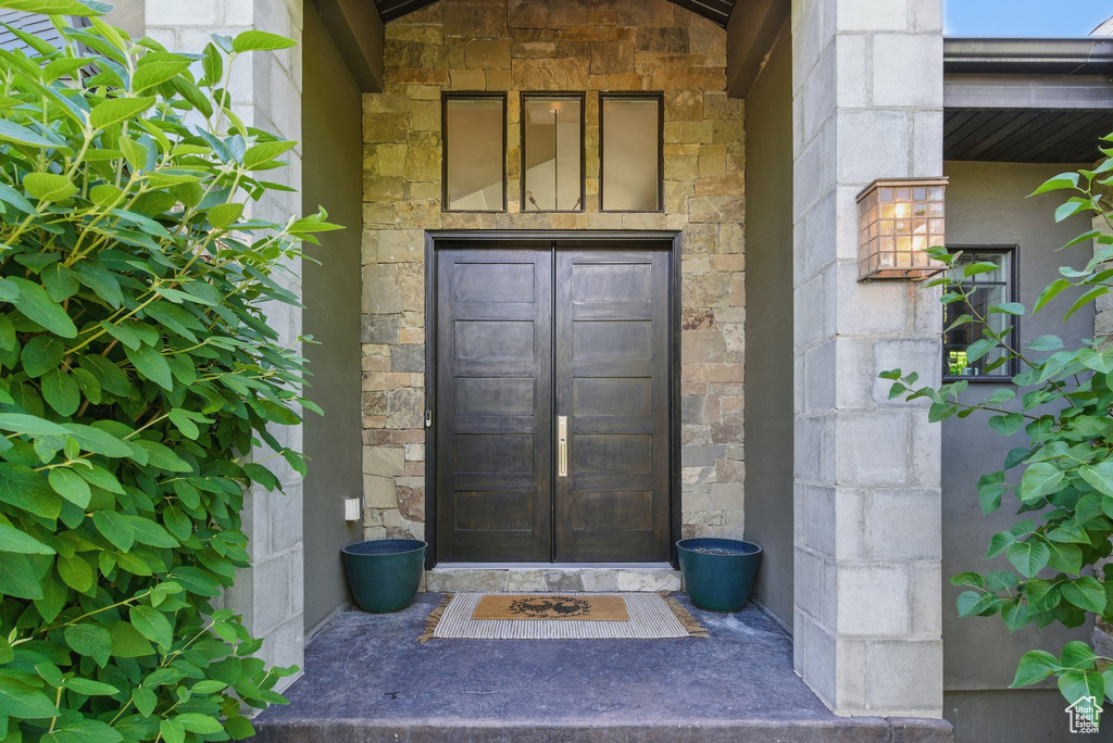 Entrance to property featuring stone siding