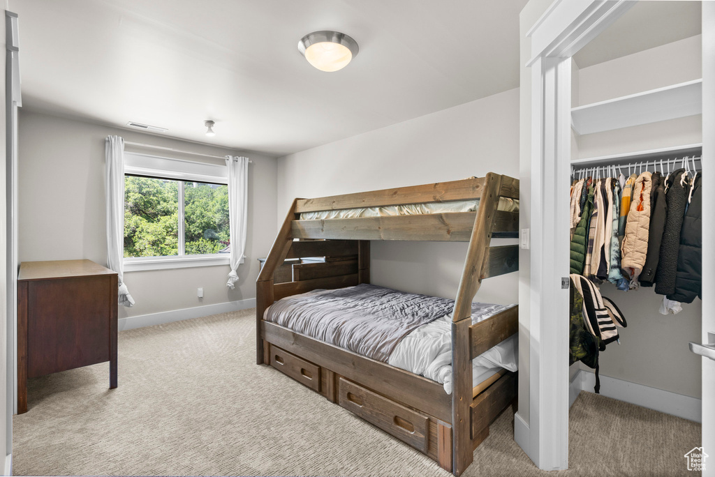Bedroom featuring carpet flooring and baseboards
