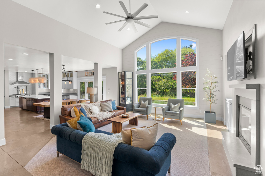 Living area featuring a fireplace, high vaulted ceiling, a ceiling fan, and recessed lighting