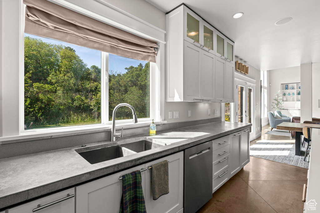 Kitchen with dishwasher, a sink, glass insert cabinets, recessed lighting, and french doors