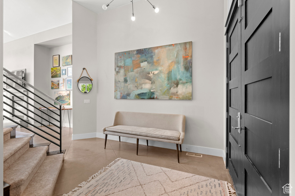 Entryway with stairs and baseboards