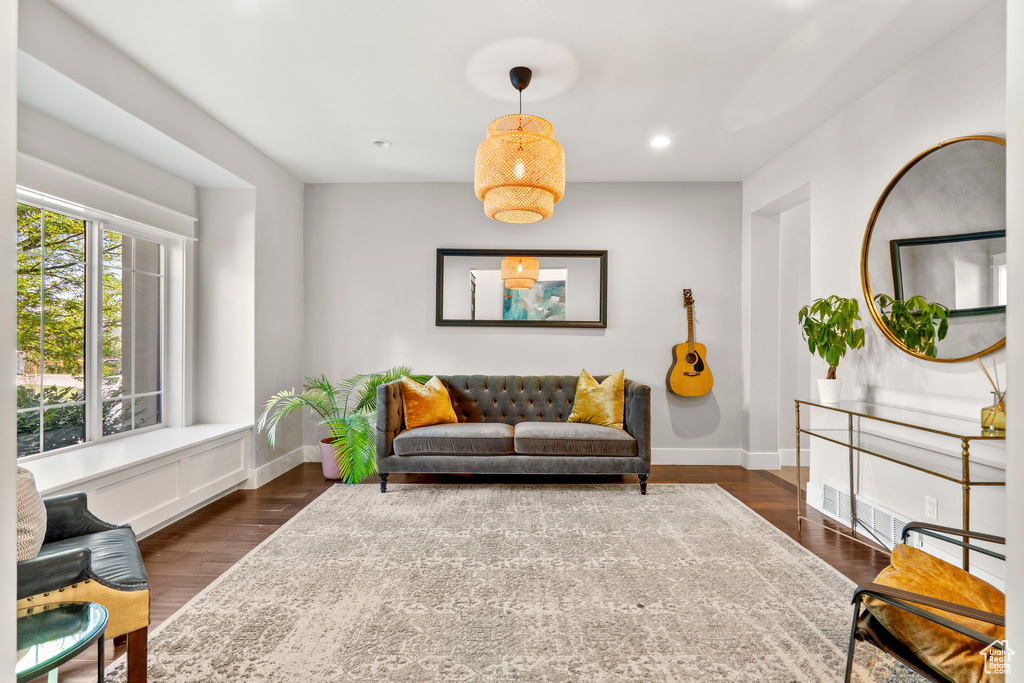Living area featuring baseboards, dark wood-style flooring, and recessed lighting