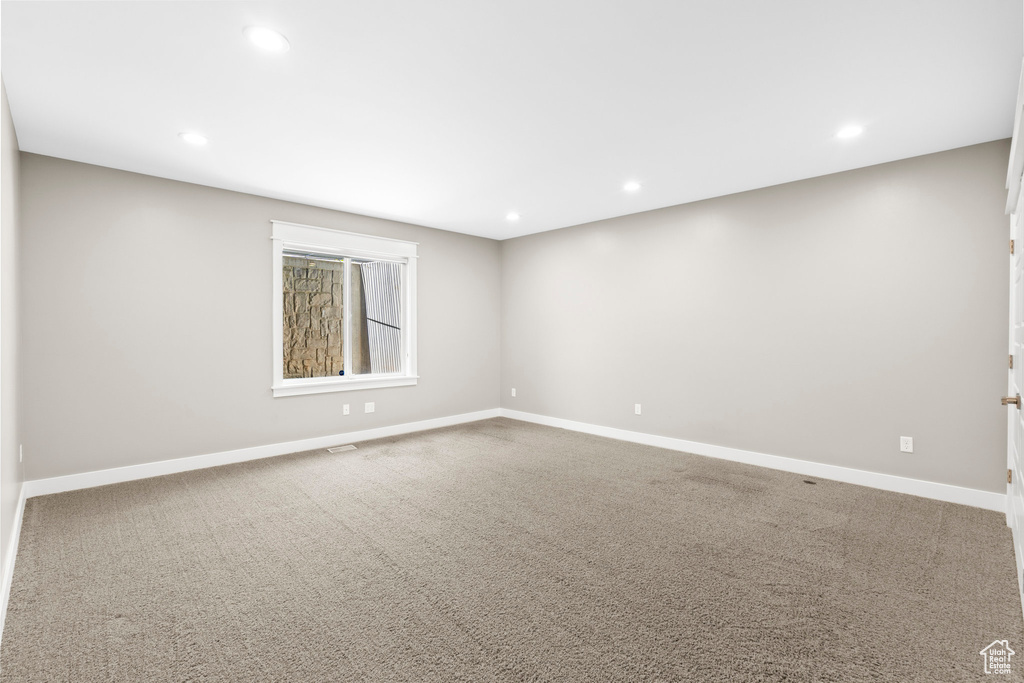 Spare room featuring baseboards, carpet floors, and recessed lighting