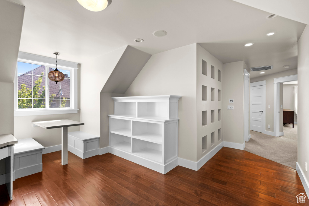 Additional living space with dark wood finished floors, baseboards, and recessed lighting