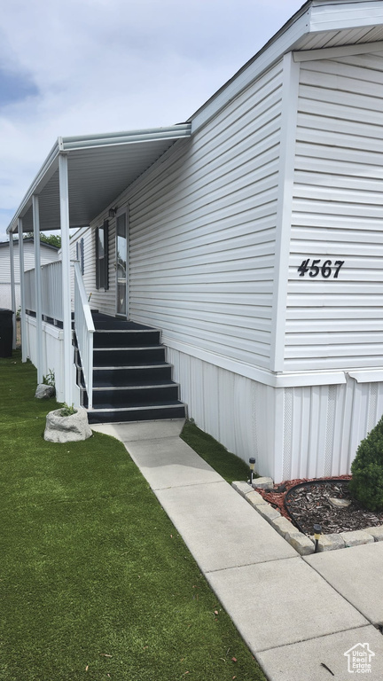 Doorway to property featuring a yard