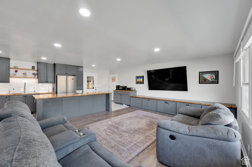 Living room featuring light wood-type flooring and recessed lighting